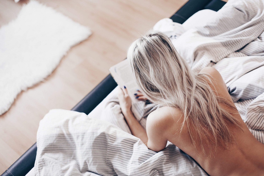 free-spirit-woman-reading-a-book-in-bed-2210x1473.jpg